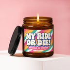 Amber candle with lit flame and lid. Label reads "MY RIDE OR DIE! MY MAID OF HONOR".