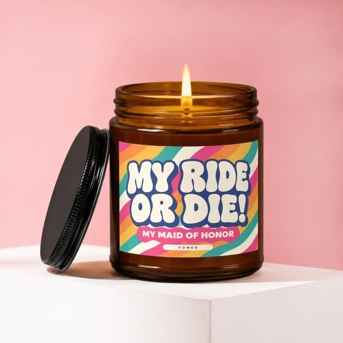 Amber candle with lit flame and lid. Label reads "MY RIDE OR DIE! MY MAID OF HONOR".