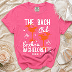 Pink t-shirt with "The Bach Club Emelia's Bachelorette Miami, FL" text.