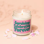 Burning candle with label "Surviving Celebrating Forever Vowed" surrounded by petals.