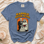Blue t-shirt with skeleton bride and groom cutting a cake design and text "Happily Never After 'Til Death Do Us Part".