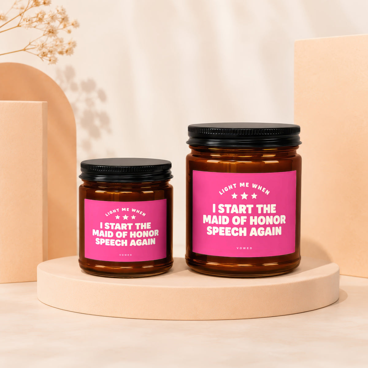 Two candles with pink labels reading "Light Me When I Start The Maid of Honor Speech Again".