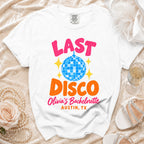 White t-shirt with "Last Disco," "Olivia's Bachelorette," and "Austin, TX" graphics.
