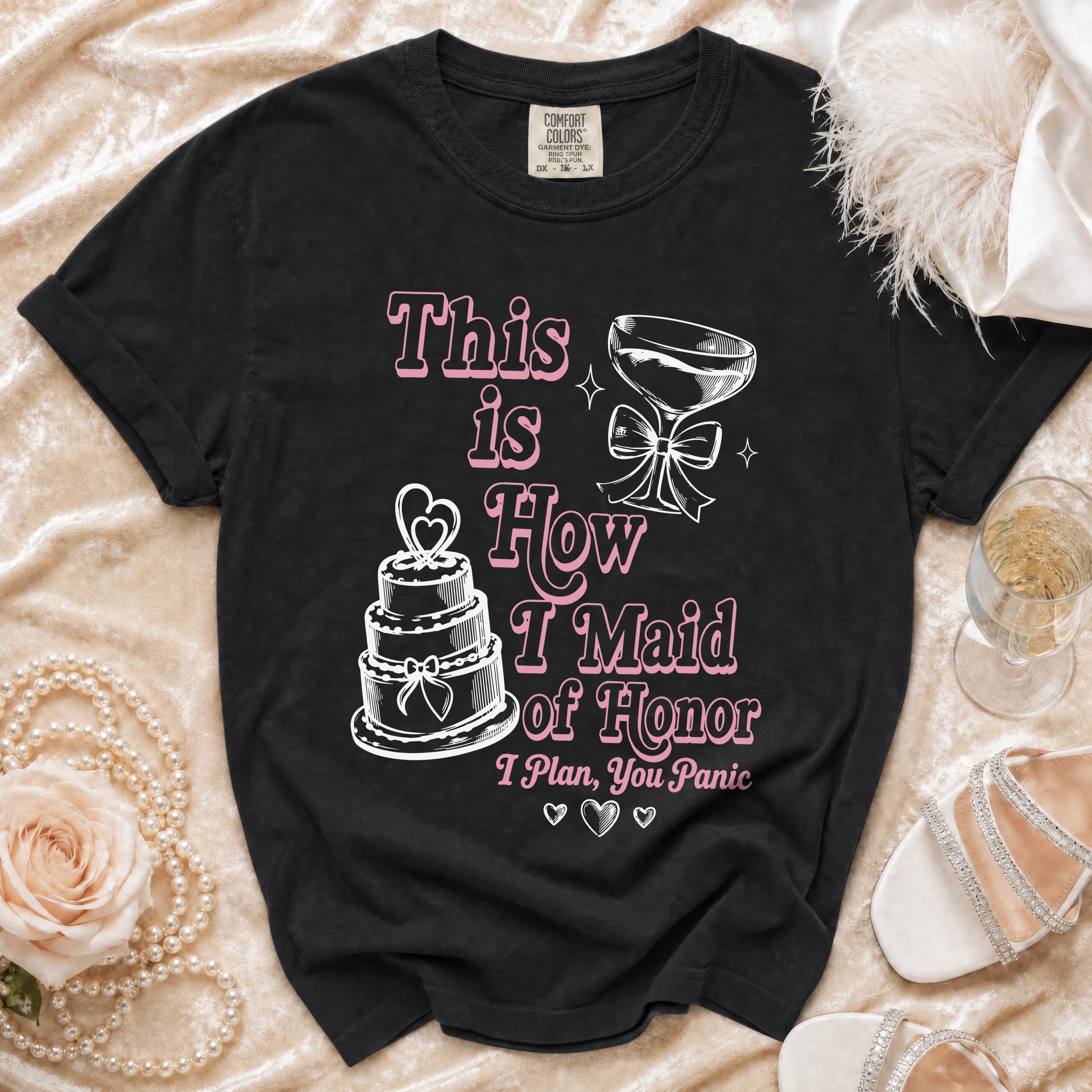 Black t-shirt with "This is How I Maid of Honor I Plan, You Panic" text and illustrations.