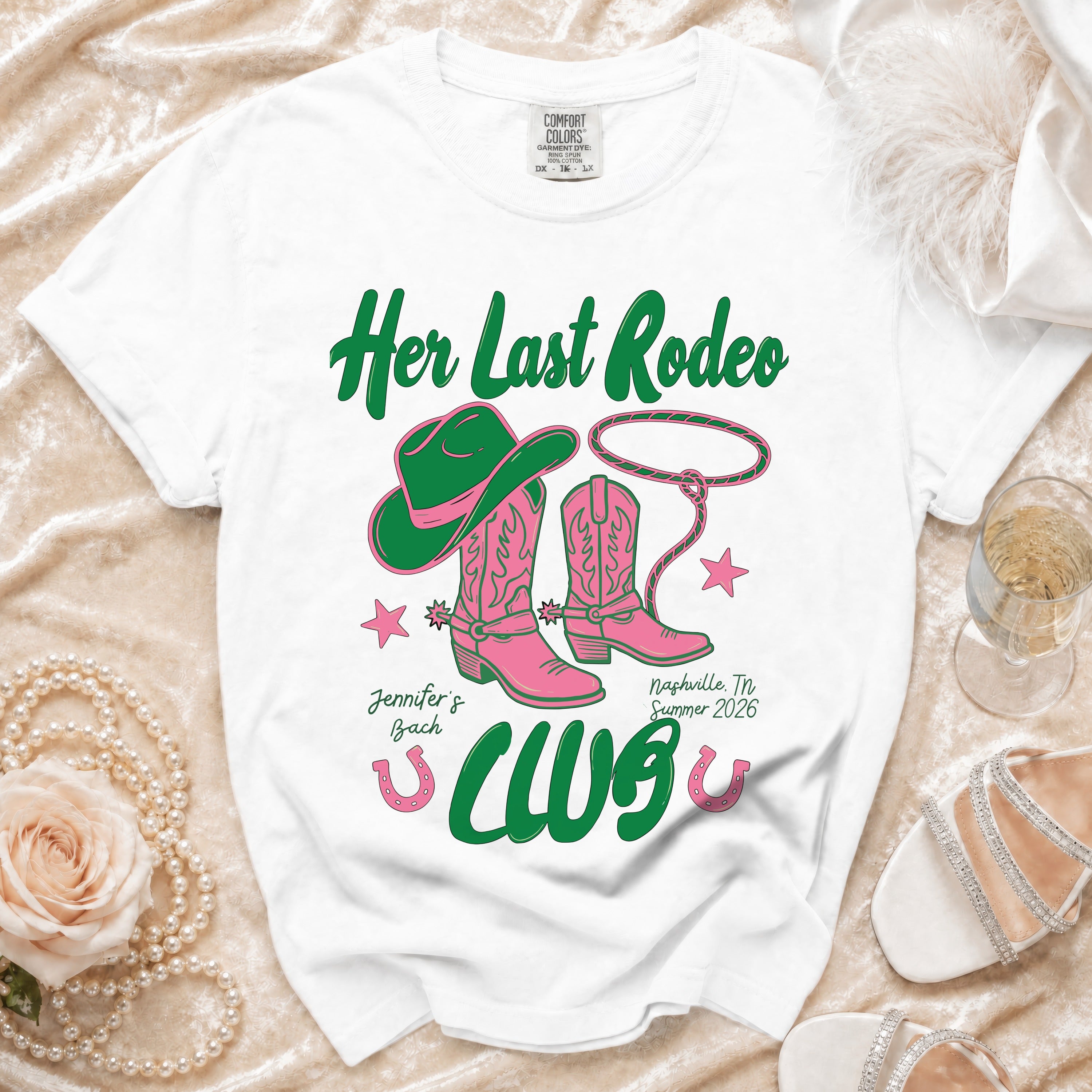 White t-shirt with pink cowboy boots and hat, "Her Last Rodeo" text.