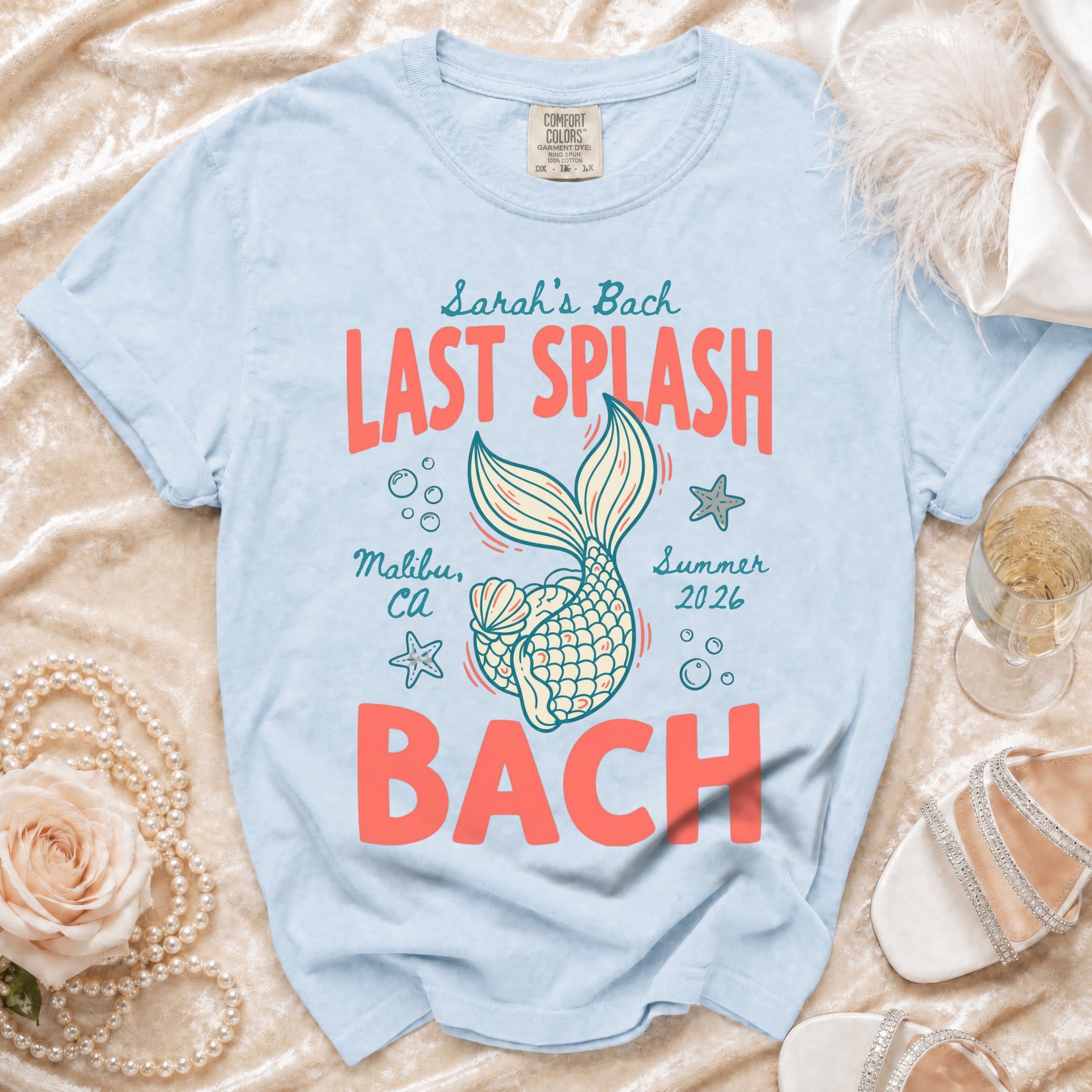 Light blue t-shirt with "Sarah's Bach LAST SPLASH Malibu, Ca Summer 2026 BACH" in coral.