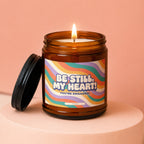 Amber jar candle with lit flame and text "Be Still, My Heart! You're Engaged!".