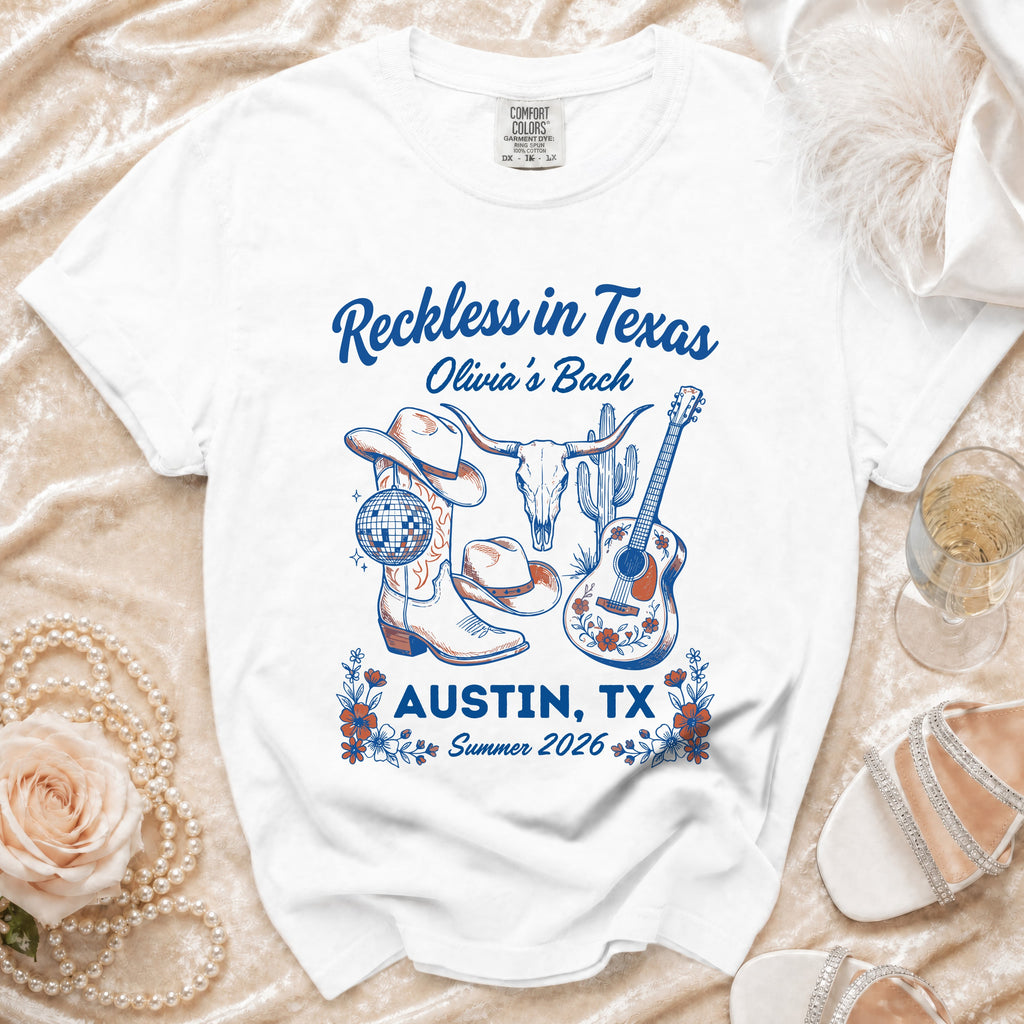 White t-shirt with "Reckless in Texas" and Austin graphics.