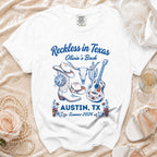 White t-shirt with "Reckless in Texas" and Austin graphics.