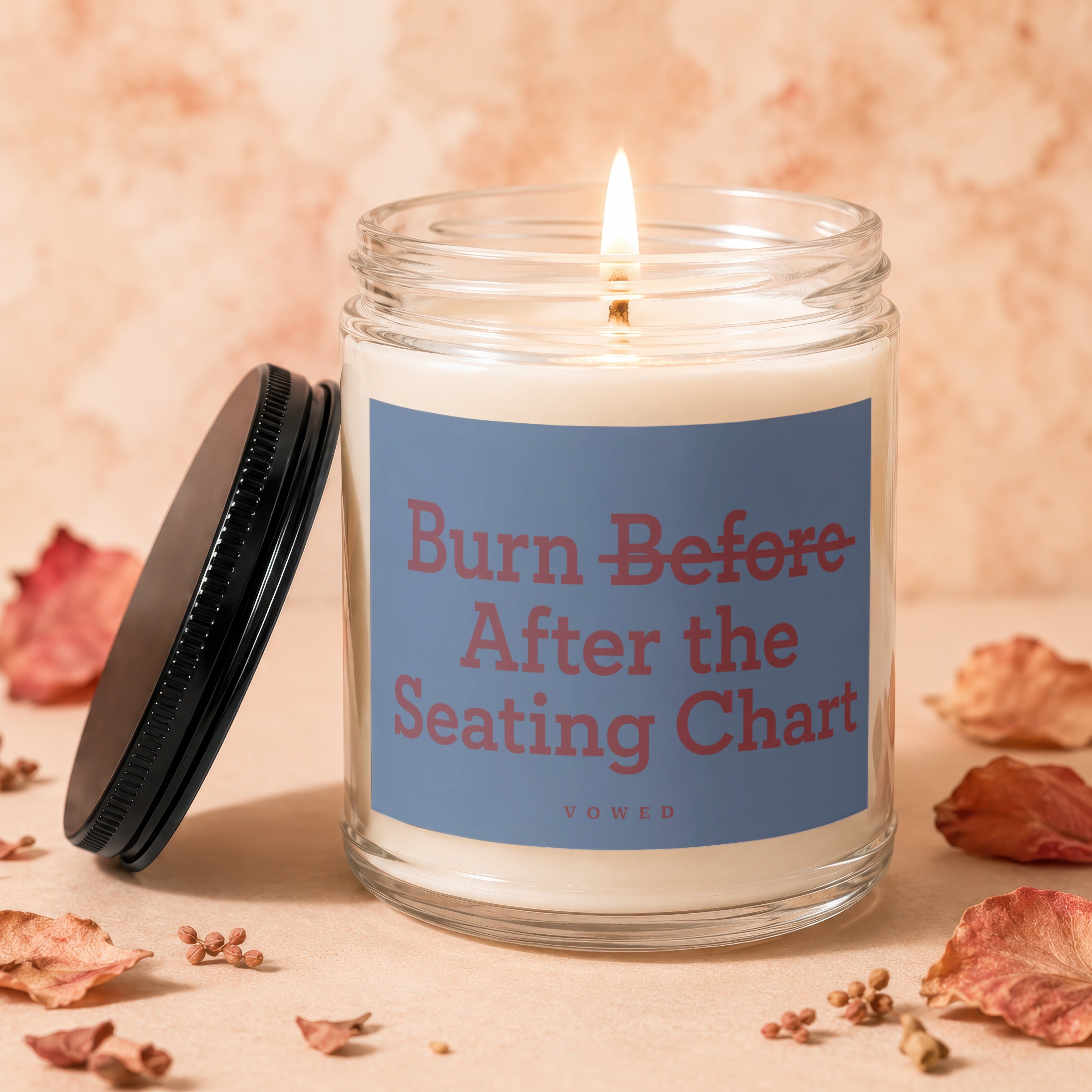 Glass jar candle with "Burn Before After the Seating Chart" text.