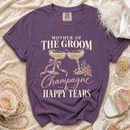 Purple t-shirt with "Mother of the Groom Champagne & Happy Tears" text and champagne glasses.