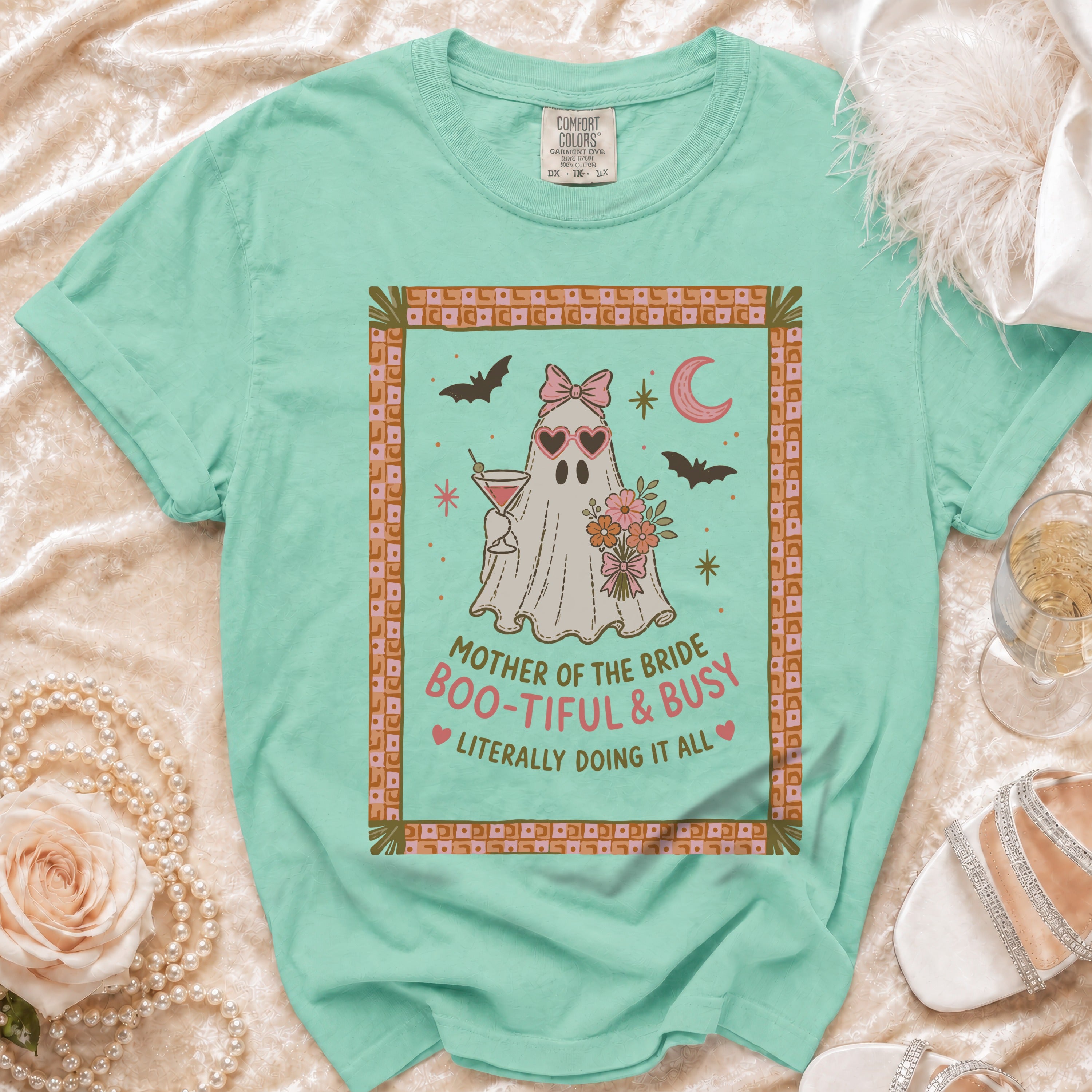 Mint green t-shirt with a ghost graphic that reads "Mother of the Bride Boo-tiful & Busy".