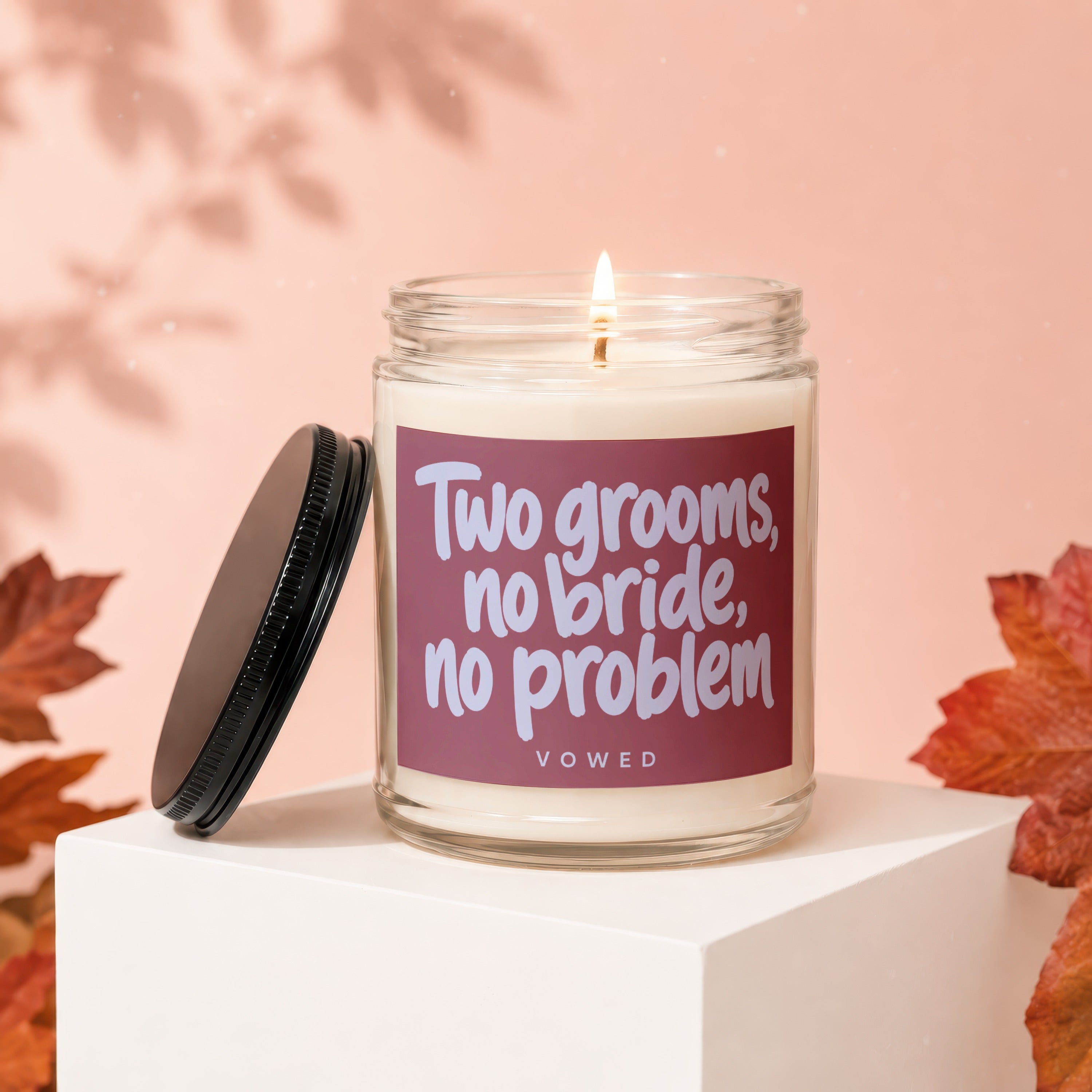 Candle with text "Two grooms, no bride, no problem" and "VOWED".
