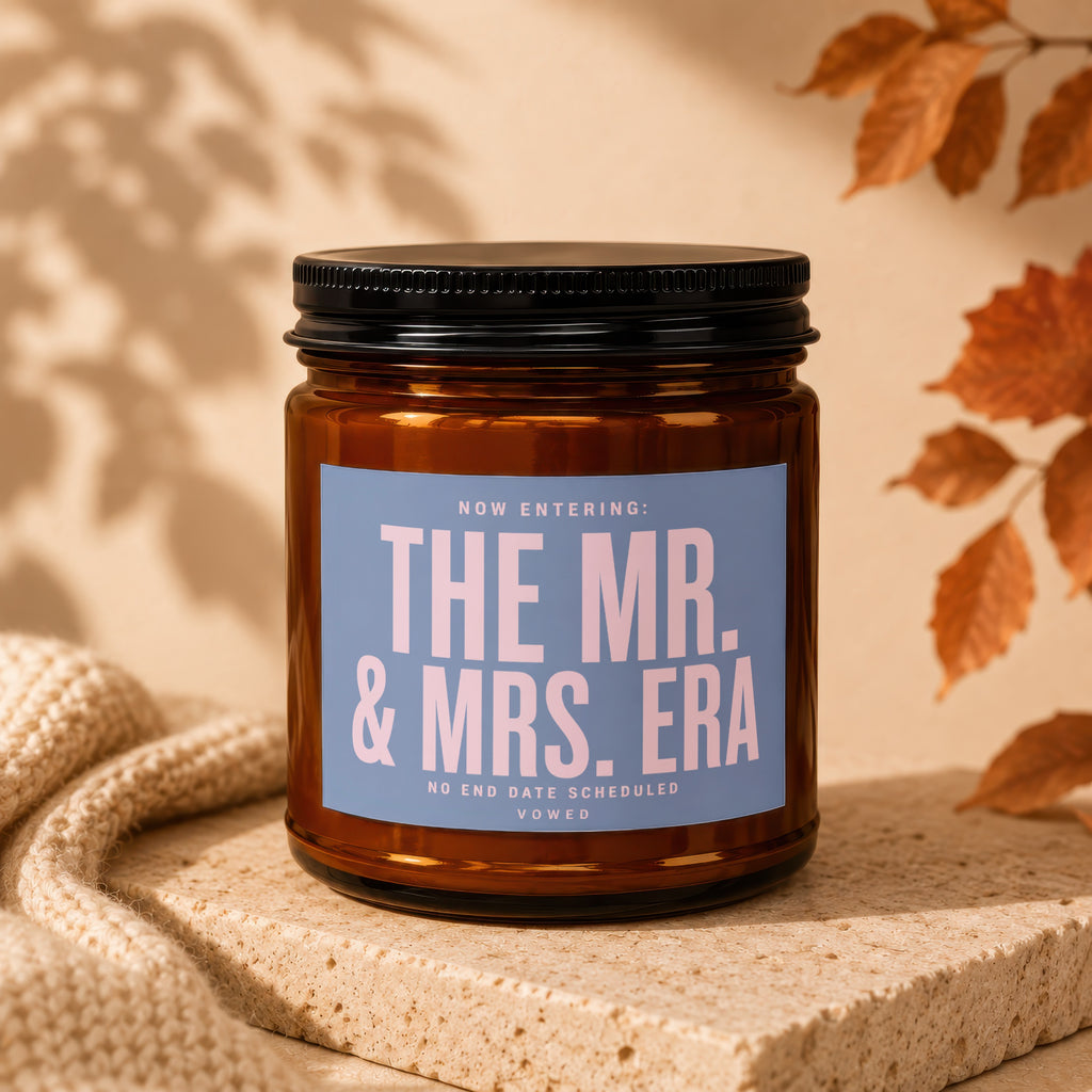 Amber jar candle labeled "The Mr. & Mrs. Era" with "No End Date Scheduled. Vowed."