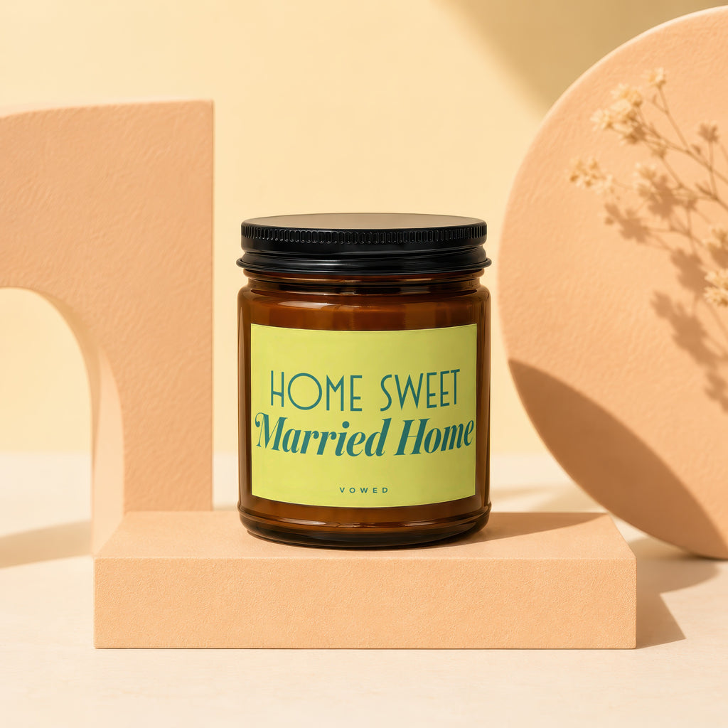 Brown glass candle with black lid and "Home Sweet Married Home" label.