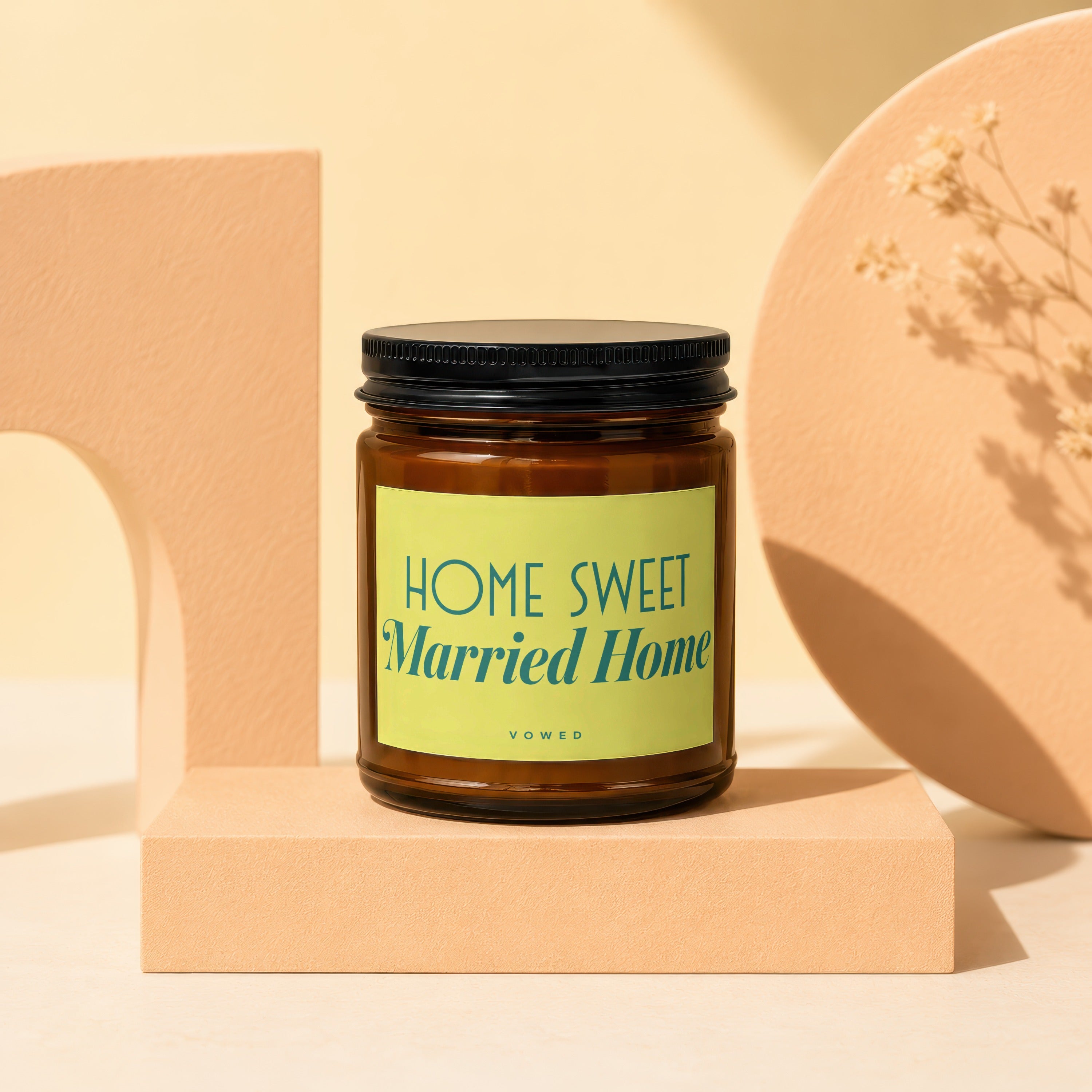 Brown glass candle with black lid and "Home Sweet Married Home" label.