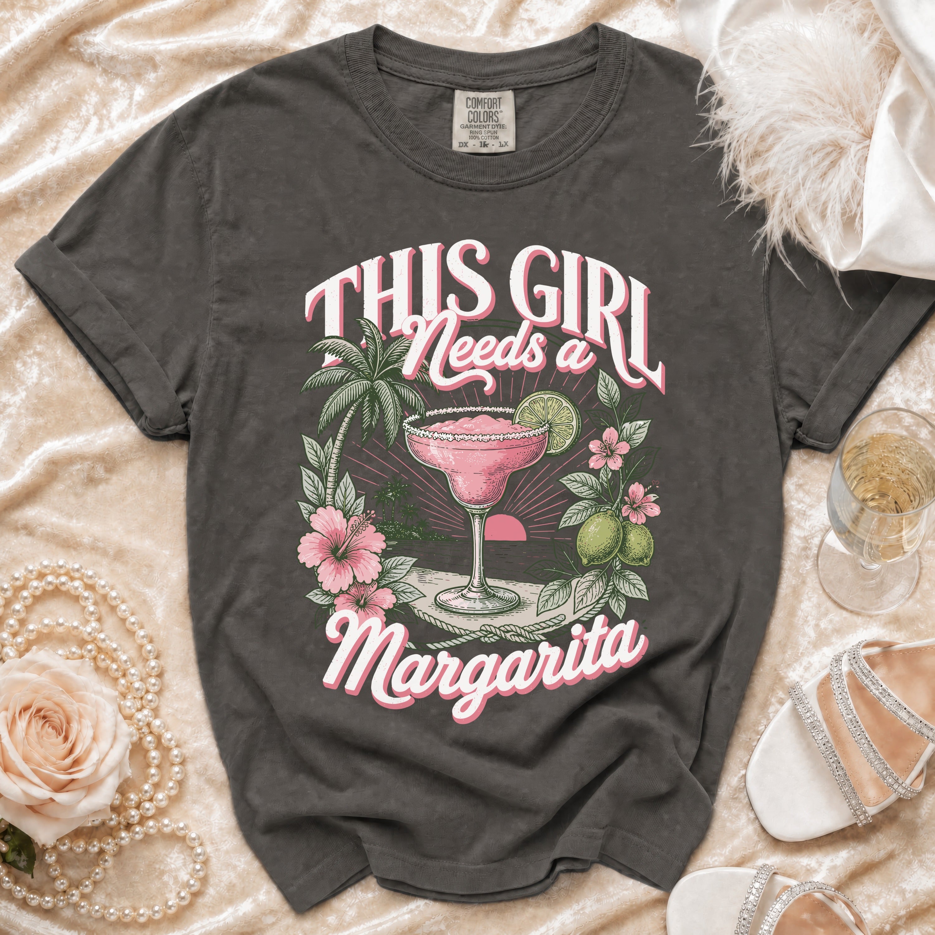 Dark grey t-shirt with "This Girl Needs a Margarita" graphic and margarita illustration.