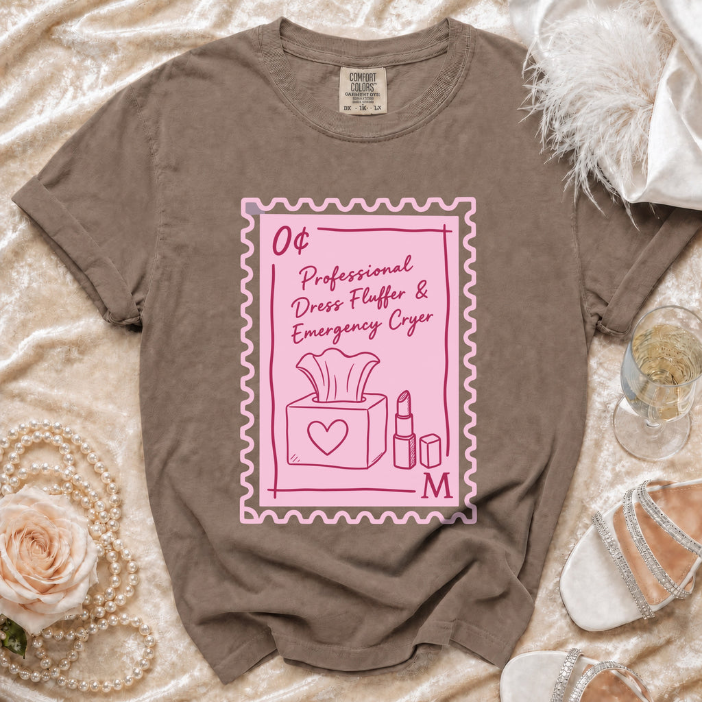 Brown t-shirt with a pink postage stamp graphic reading "0¢ Professional Dress Fluffer & Emergency Cryer".