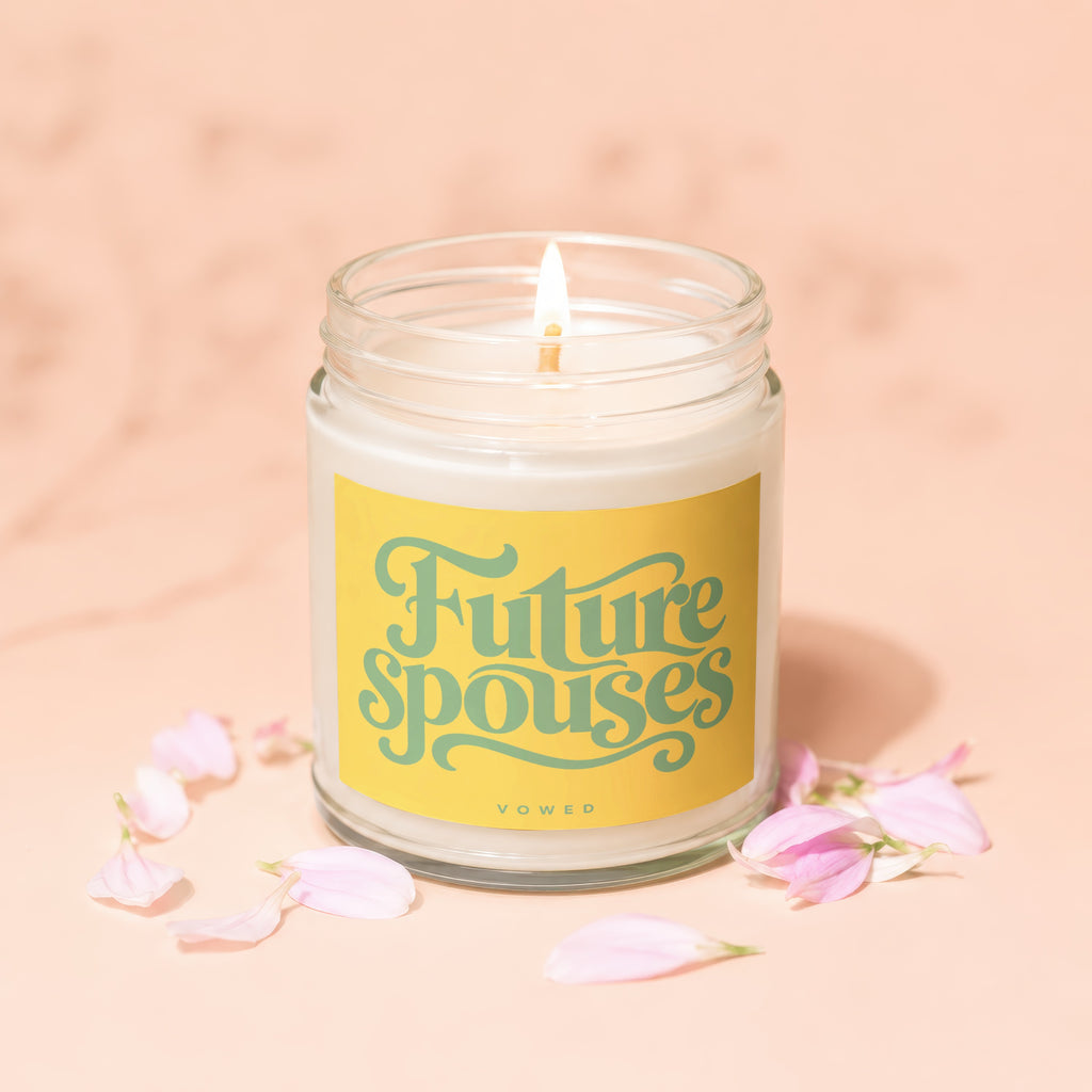 Lit candle in a glass jar with a yellow label saying "Future Spouses Vowed".