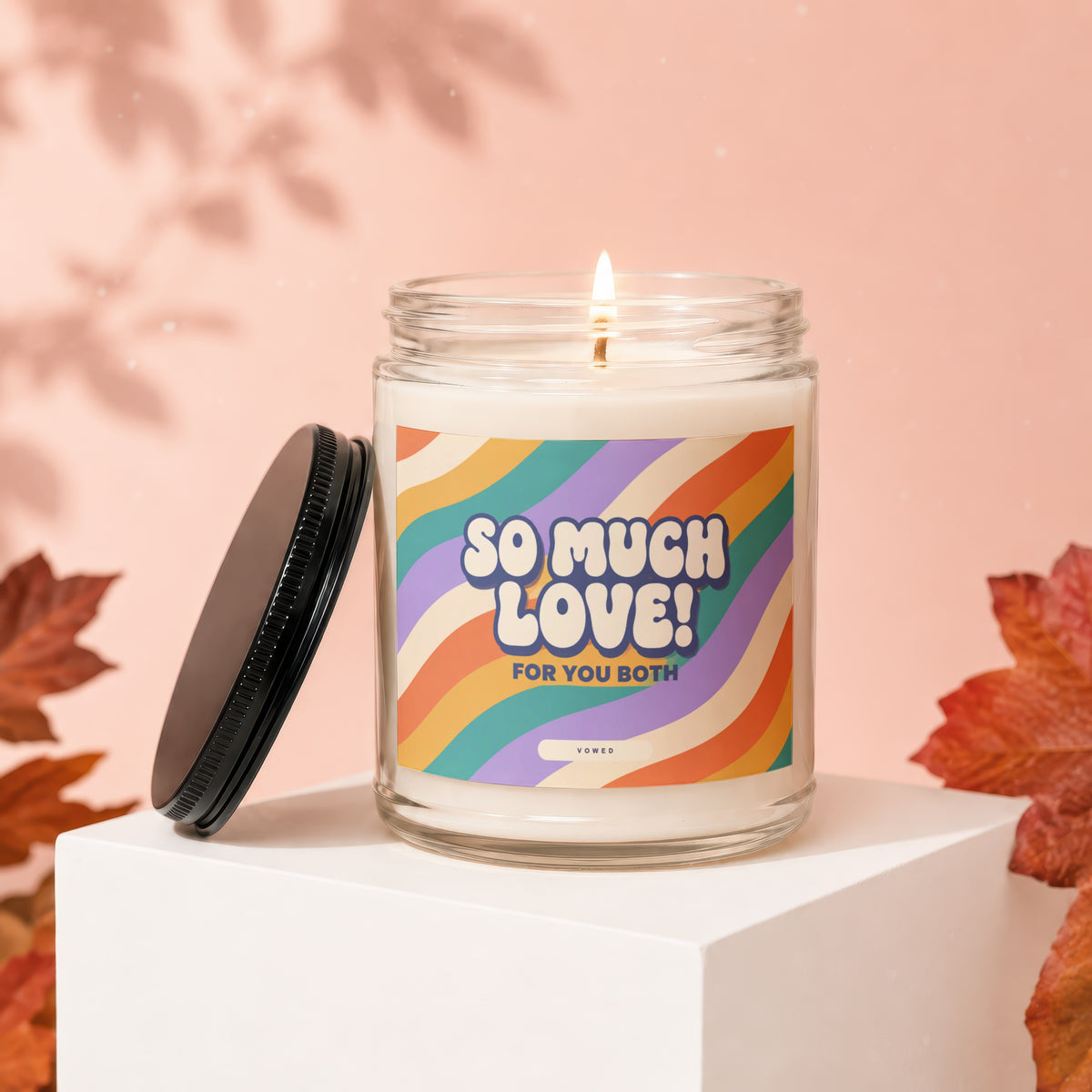 Glass candle with "SO MUCH LOVE! FOR YOU BOTH" text and colorful stripes.
