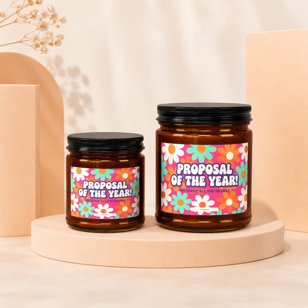 Two amber jars with black lids, featuring "Proposal of the Year!" text and floral designs.