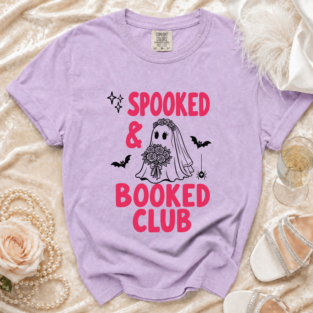 Lavender t-shirt with "Spooked & Booked Club" graphic of a ghost bride and bats.