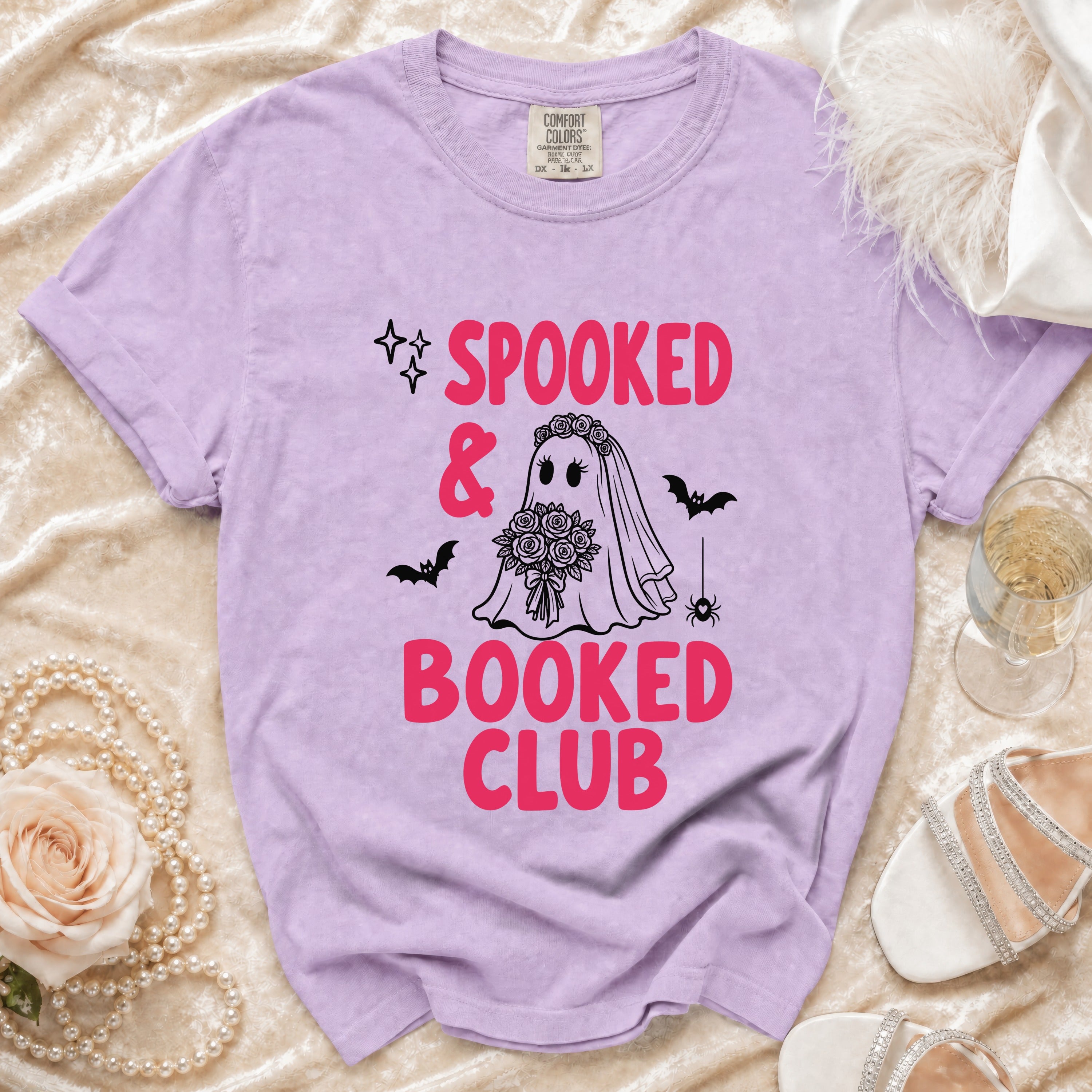 Lavender t-shirt with "Spooked & Booked Club" graphic of a ghost bride and bats.