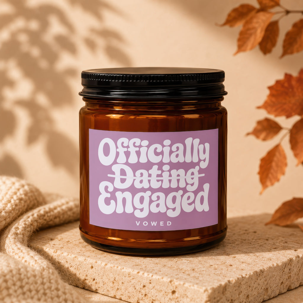 Amber candle with lavender label reading "Officially Dating Engaged VOWED".