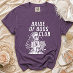 Purple t-shirt with "Bride of Boos Club" text and skeleton bride graphic.