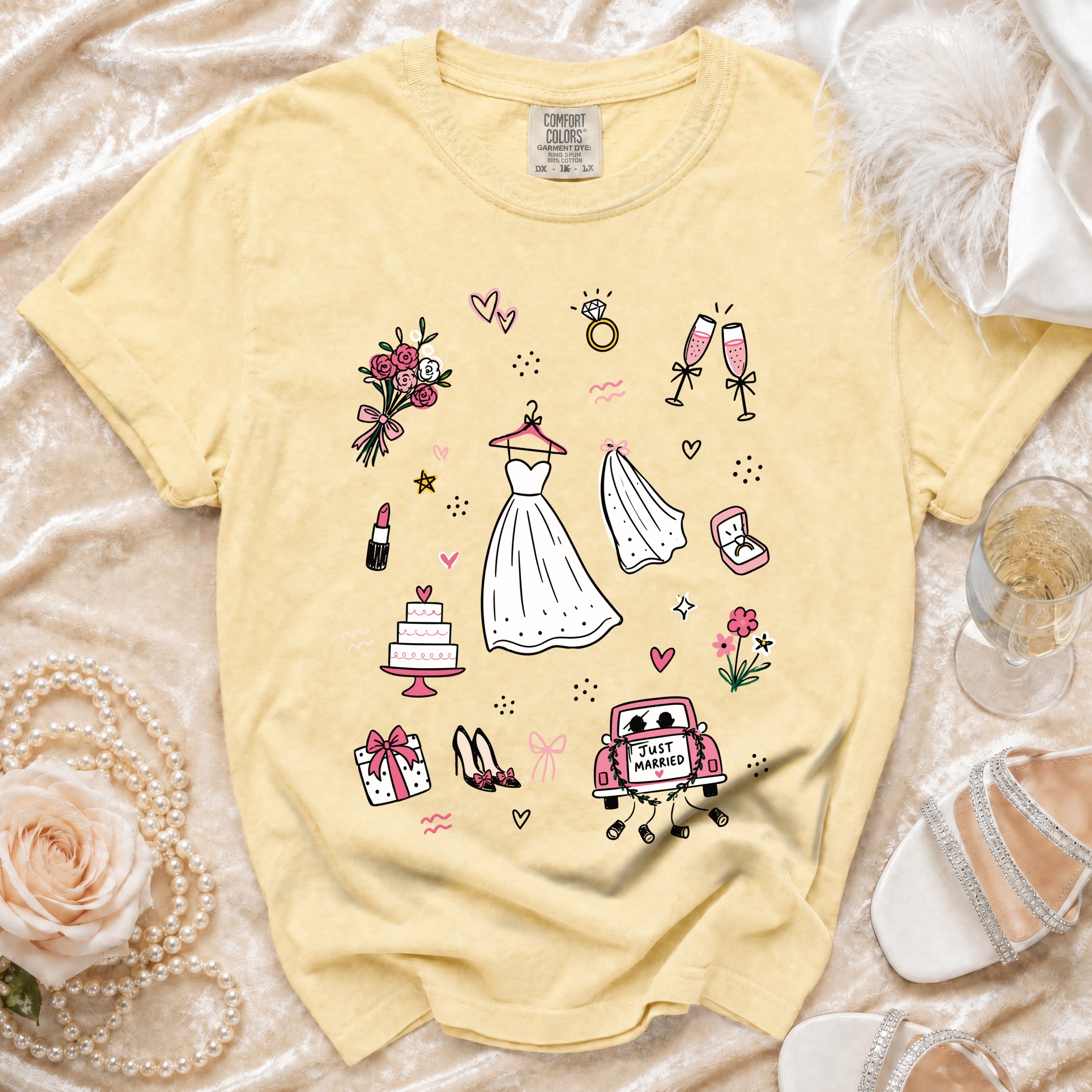 Yellow t-shirt with wedding illustrations: dress, veil, cake, and "Just Married" car.