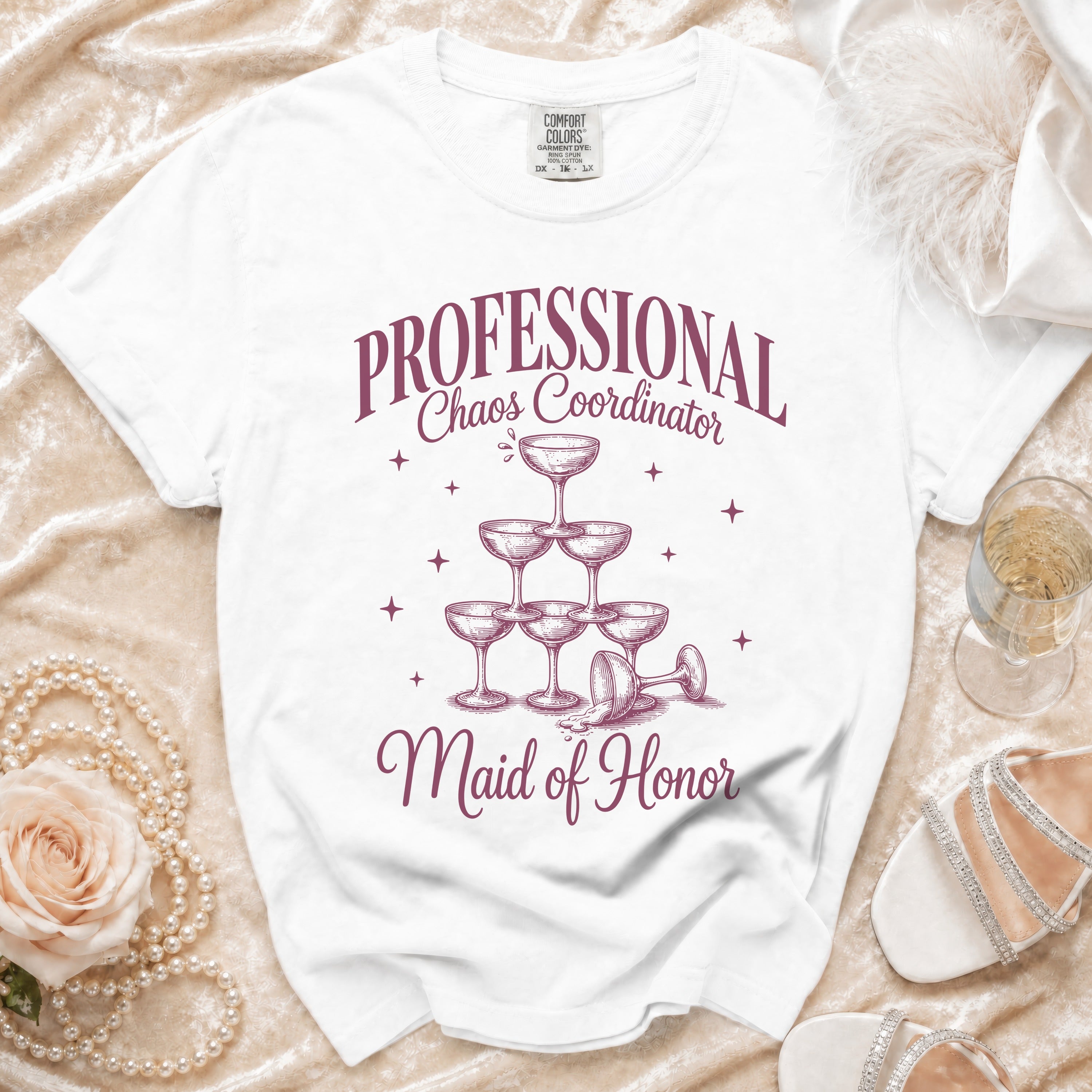 White t-shirt with "Professional Chaos Coordinator Maid of Honor" text and champagne glass pyramid graphic.