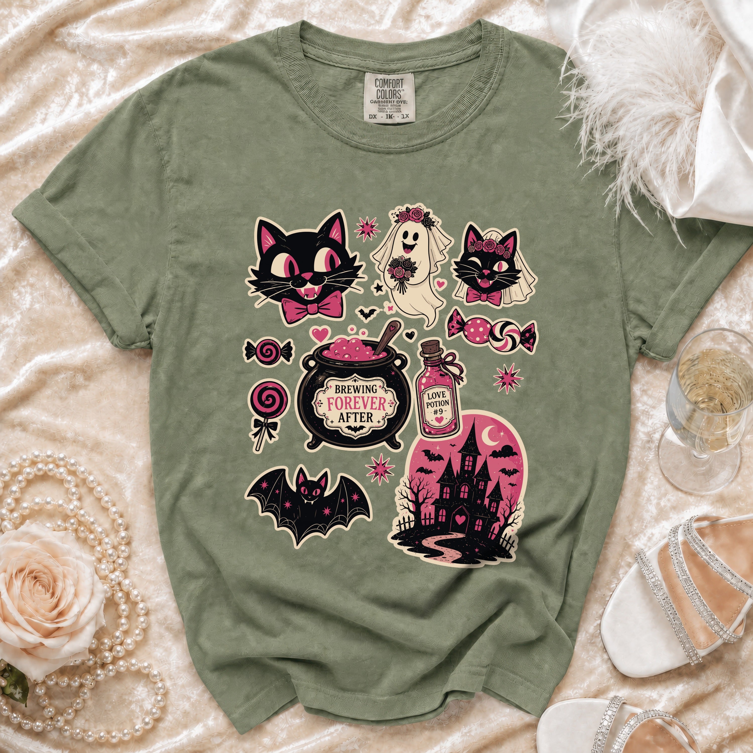 Green t-shirt with Halloween graphics including cats, a ghost, bat, and haunted house.