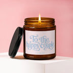 Amber jar candle with lit flame, reads "To the happy couple" and "VOWED".