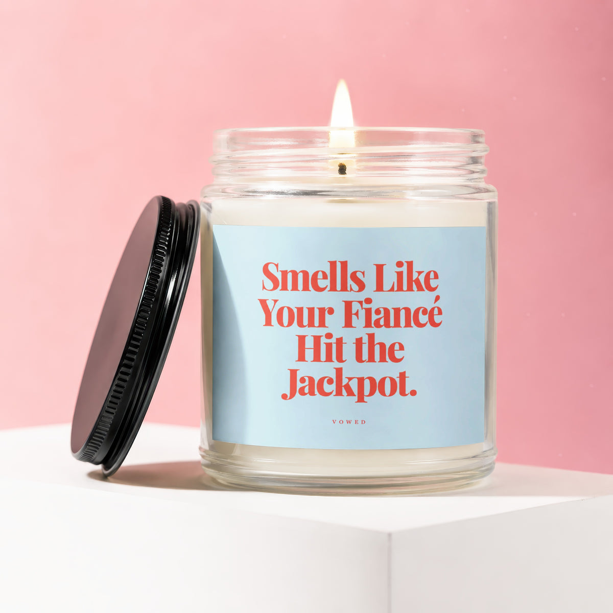 Candle with text "Smells Like Your Fiancé Hit the Jackpot."