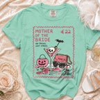 Teal Comfort Colors shirt with "MOTHER OF THE BRIDE NO TRICKS, JUST STRESS" graphic.