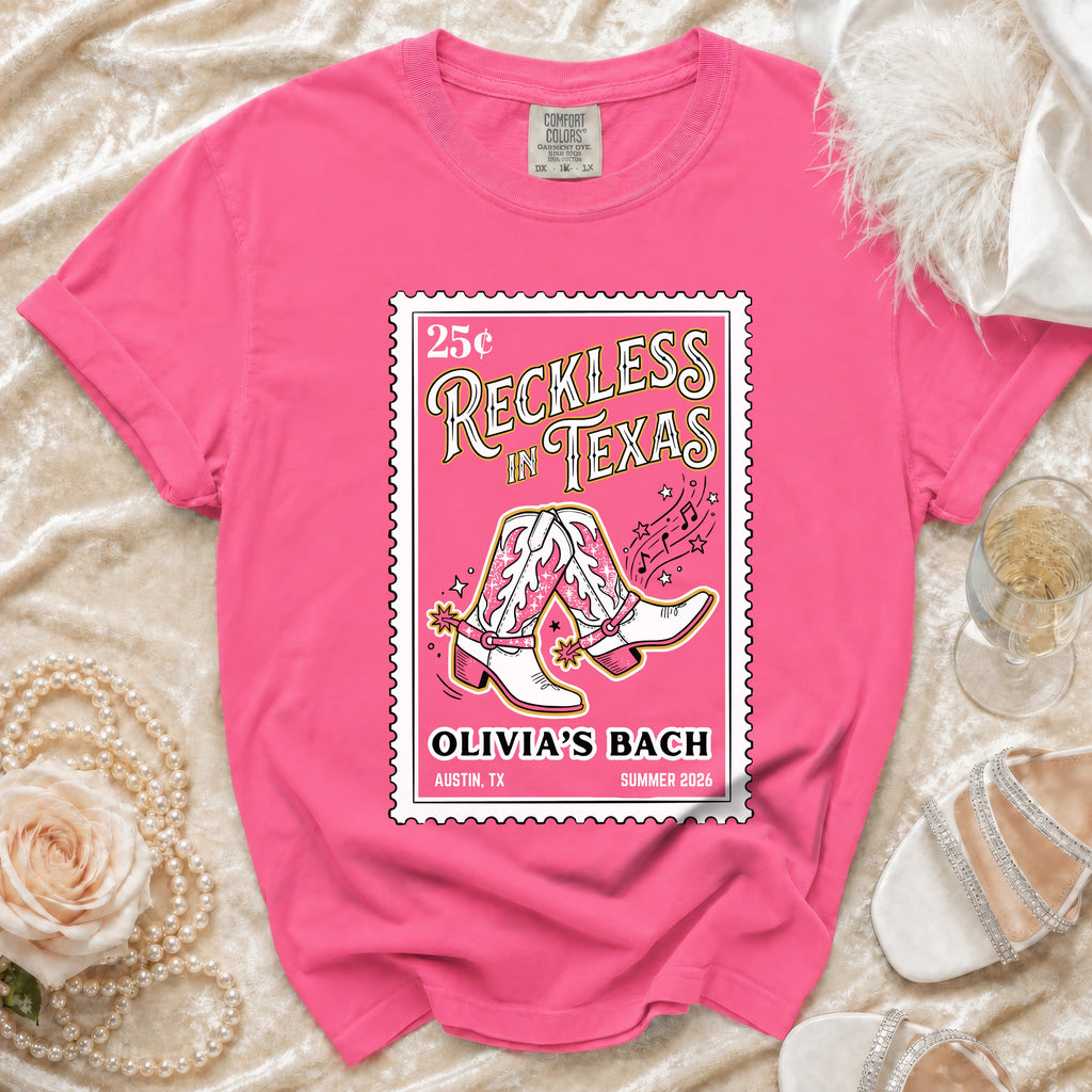 Pink t-shirt with "Reckless in Texas" graphic, cowboy boots, and Olivia's Bach text.