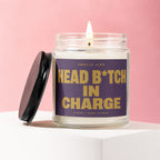 Candle with "Smells like head b*tch in charge" text and lit wick.