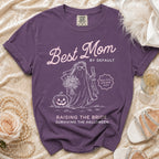 Purple Comfort Colors t-shirt with "Best Mom By Default" and Halloween ghost bride graphic.