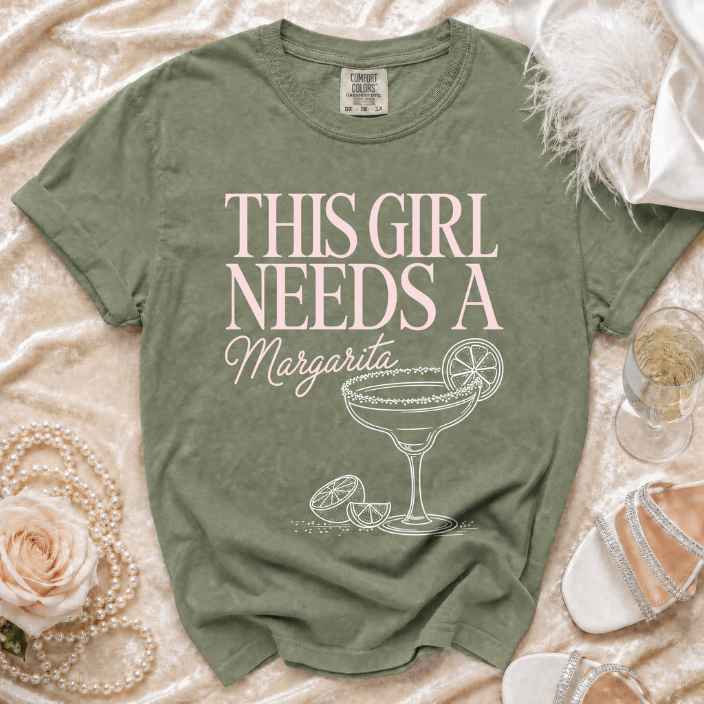 Green t-shirt with "This girl needs a Margarita" text and margarita illustration.
