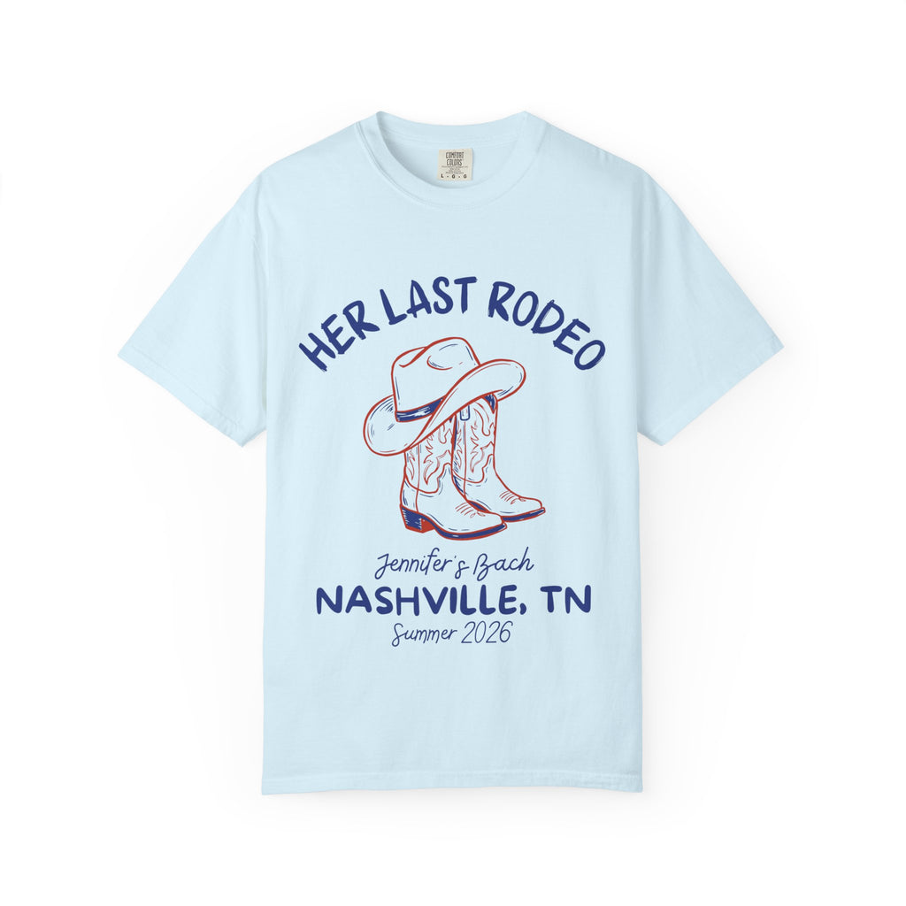 Light blue t-shirt with cowboy hat, boots, and "Her Last Rodeo" text.