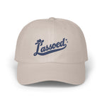 A light gray baseball cap features the blue embroidered script text Lassoed across the front.