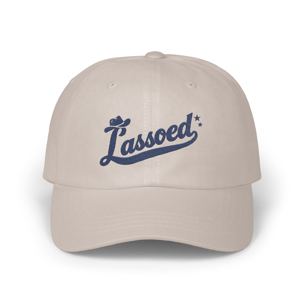 A light gray baseball cap features the blue embroidered script text Lassoed across the front.