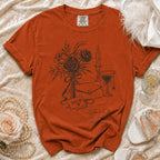 Orange Comfort Colors t-shirt with floral sketch and text "Mother of the Bride, No Tricks, Just Trauma."
