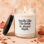 Glass candle with lit wick and black lid, reads "Smells Like The Bride Is Always Right."