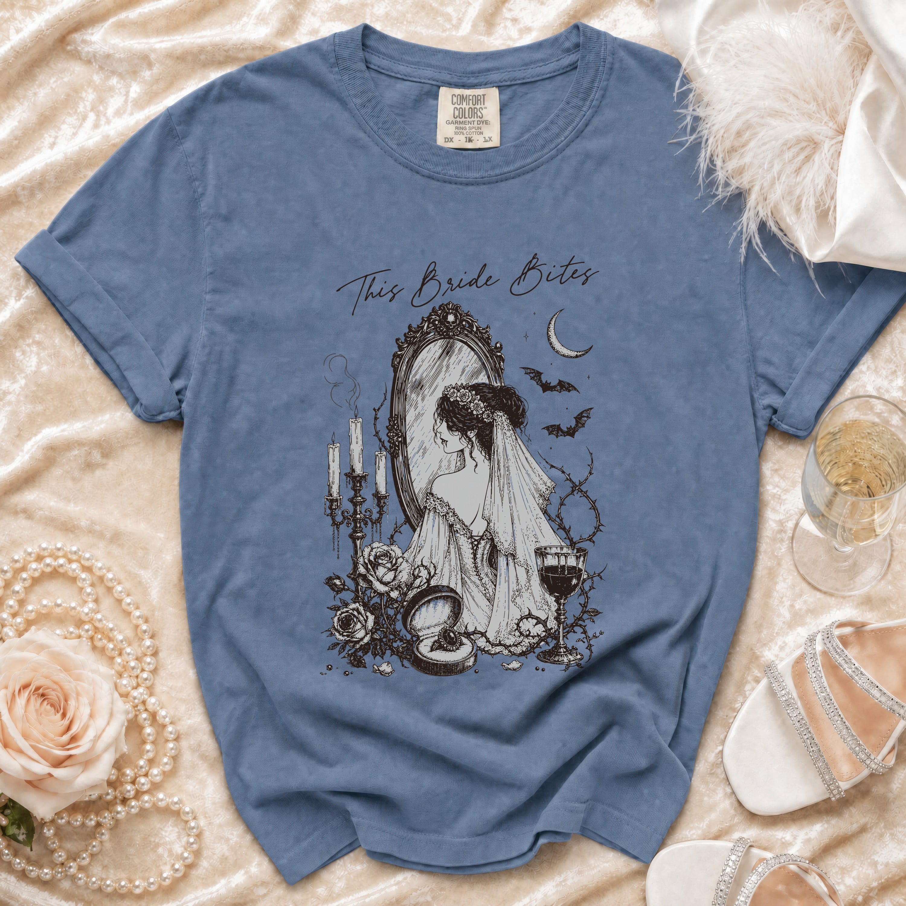 Blue t-shirt with "This Bride Bites" gothic bride illustration and skull motif.
