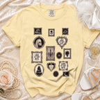 Yellow Comfort Colors t-shirt with gothic wedding-themed icons and "Love at First Bite" text.