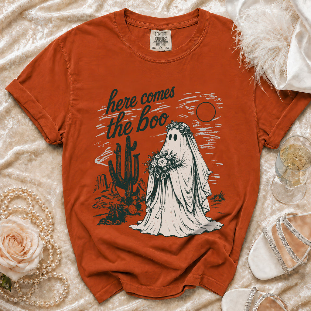 Orange t-shirt with "here comes the boo" text and a ghost bride in a desert setting.