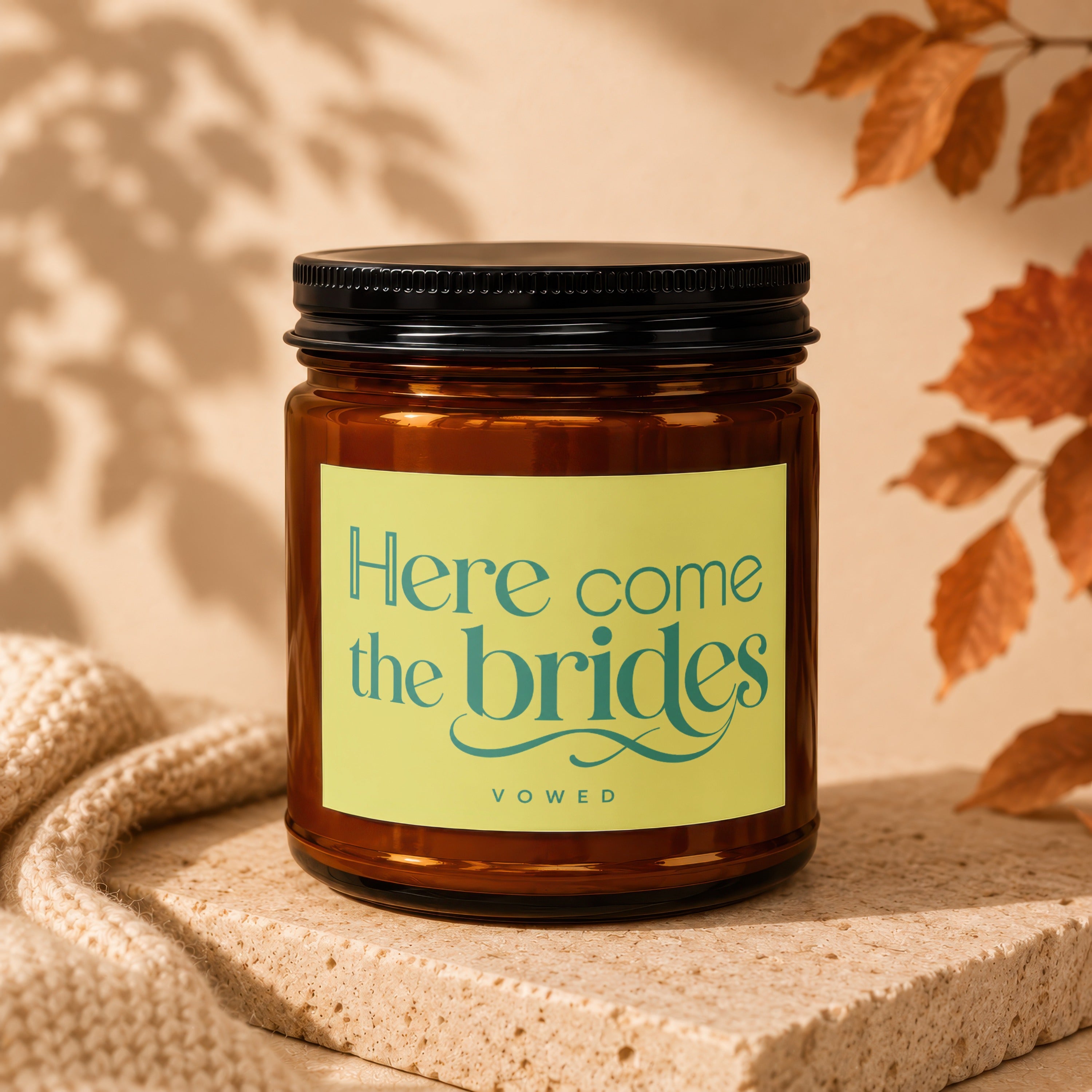 Amber candle with "Here come the brides" and "vowed" on a light green label.
