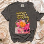 Gray t-shirt with "Wifey Wants a Spritz" design, champagne, and bridal accessories.