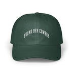Dark green baseball cap with white embroidered text reading FOUND HER COWBOY arched across the front panels.